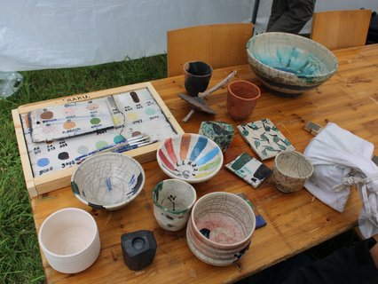 Workshopleiter Jaimun Kim hat schon fertige Gefäße und Objekte mitgebracht. So konnte man sehen, wie die Glasuren im gebrannten Zustand aussehen. Viele farbige Glasuren standen zur Auswahl